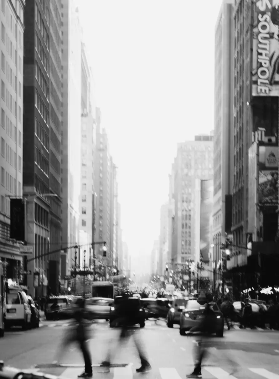 Black and white photo of people walking across NYC street